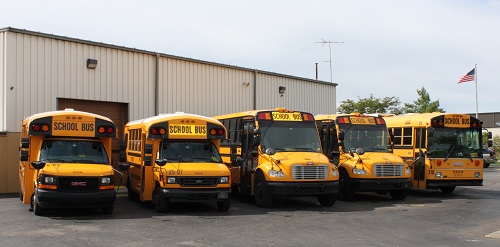Five buses in the ServiCar bus fleet, holding a variety of passengers with adaptive equipment for special needs transporation.